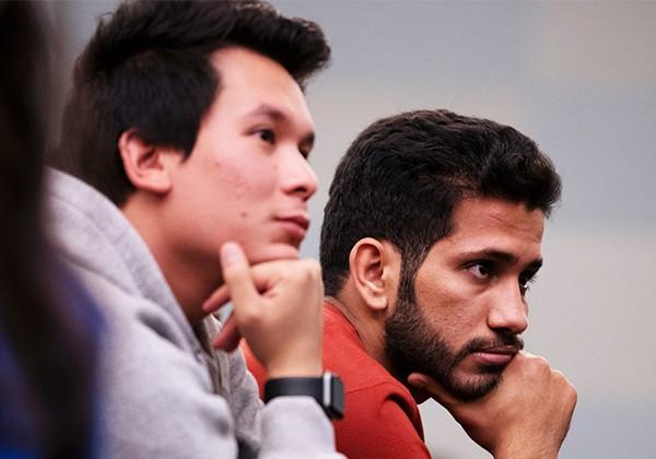 two students listening pensively